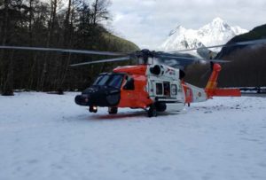 An MH-60 Jayhawk helicopter from Coast Guard Air Station Sitka sits on a snowy riverbank. Photo by Petty Officer 1st Class Ali Blackburn