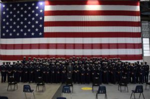 Prior to the Coast Guard Cutter Douglas Munro (WHEC 724) decommission ceremony the crew of the Douglas Munro poses for a group photo with Signalman 1st Class Douglas Munro’s nephew, former Cmdr. Douglas Sheehan in Kodiak, Alaska.  Coast Guard photo by Petty Officer 3rd Class Janessa Warschkow