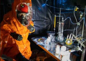 Sgt. Anthony Luiken, 103rd Civil Support Team, and Staff Sgt. Jonathan Ramos, 103rd CST, collect and seal samples at a simulated incident at the Anchorage Fire Training Center. (U.S. Army National Guard photo by Spc. Grace Nechanicky)