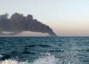 This image made from a video released on Wednesday, June 2, 2021 by Asriran.com, shows smoke rising from Iran's navy support ship Kharg in the Gulf of Oman.