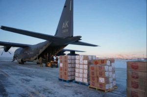 Members for the 176th Wing, Alaska Air National Guard unload pallets of gifts from an HC-130J Combat King II aircraft. (U.S. Army National Guard photo by Dana Rosso/Released).