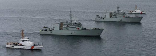 U.S. Coast Guard Cutter Blue Shark [WPB 87360] and U.S. Coast Guard Cutter Osprey [WPB 87307] flank HMCS Saskatoon and HMCS Yellowknife from the Royal Canadian Navy during a joint exercise in the Salish Sea on Feb. 17, 2022. The exercise was conducted to train and prepare Royal Canadian Navy crews for deployments to support United States counter-narcotics operations. (U.S. Coast Guard photo by Petty Officer 2nd Class Steve Strohmaier)