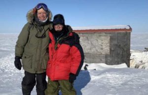 George Divorky and his friend Matt Thomas pose in front of George's cabin on Cooper Island after repairing the Polar Bear damage in April 2022. Photo by Craig George