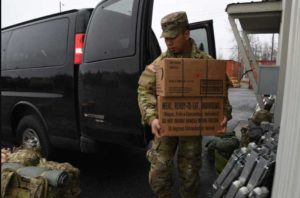 Spc. Steven Romero of the Alaska Army National Guard, 297th Military Police Company, loads MREs into a military vehicle in preparation to travel to Manley Hot Springs. (Alaska National Guard photo by Senior Master Sgt. Julie Avey)