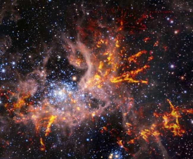 Composite infrared and radio image of 30 Doradus. Credit: ESO, ALMA (ESO/NAOJ/NRAO)/Wong et al., ESO/M.-R. Cioni/VISTA Magellanic Cloud survey. Acknowledgment: Cambridge Astronomical Survey Unit