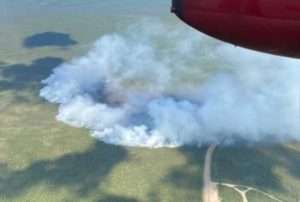  Aerial view of the Fish Fire (#319) as it spreads toward the Dalton Highway and the BLM's Arctic Circle wayside and campground.   The wayside and the road to the campground are visible in the lower right of photo. BLM photo by Ezra Butterfield. 