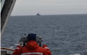 A Coast Guard Cutter Kimball crewmember observing a foreign vessel in the Bering Sea, September 19, 2022. Image-USCG