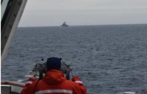 A Coast Guard Cutter Kimball crewmember observing a foreign vessel in the Bering Sea, Image-USCG