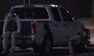 Two masked individuals dressed in tactical gear sit near a ballot dropbox location in Mesa, Arizona on October 21, 2022. (Photo: Nicole Grigg/ABC15 Arizona/Twitter Screengrab)