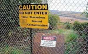 Sign and fence on contaminated ANCSA land. Image-Alaska Department of Environmental Conservation