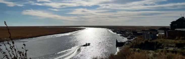 An interdisciplinary approach to coastal resilience in Alaska Chevak, on the Ningliktak River, looking towards the Bering Sea in September 2022, two weeks after Typhoon Merbok. The typhoon caused a storm surge, inundating the coastal plain several miles inland, destroying boats, nets and other equipment important to subsistence. Photo by Davin Holen/Alaska Sea Grant.