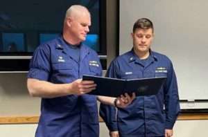 Capt. Darwin A. Jensen, Coast Guard Sector Juneau commanding officer, awards Chief Petty Officer Brian Wereda the Coast Guard Commendation Medal. (U.S. Coast Guard courtesy photo)