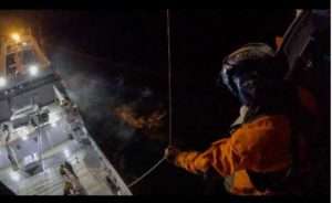 A Coast Guard Air Station Kodiak aircrew member prepares to hoist a man into a MH-60 Jayhawk helicopter approximately 30 miles north of Dutch Harbor. U.S. Coast Guard courtesy photo.