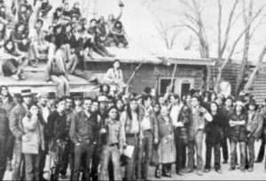 Native American activists during the Wounded Knee Occupation. Sign above door reads, “Independent Oglala Nation Wounded Knee."
