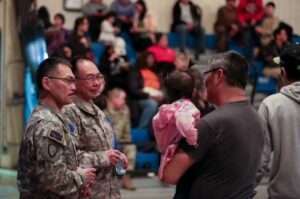 Members of the Alaska State Defense Force speak with local community members during the Cama-i Dance Festival held at the Bethel Regional High School in Bethel. (Alaska National Guard photo by Balinda O’Neal)