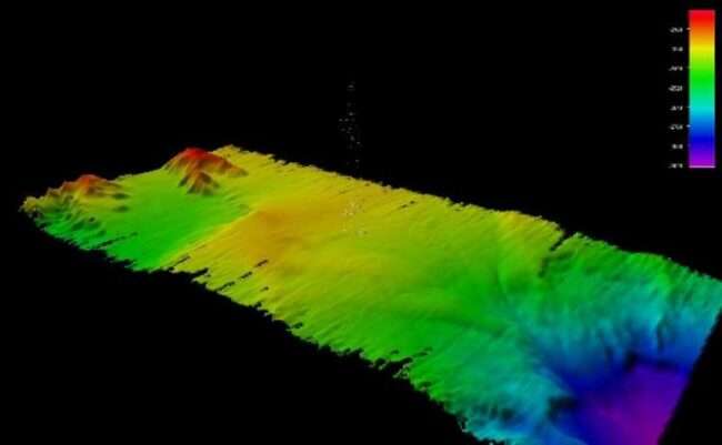Three-dimensional-modeled multibeam bathymetry data with the gas seep bubbles detected near the Aleutian Trench during the Seascape Alaska 1: Aleutians Deepwater Mapping expedition depicted as pixels extending from the middle of the model. (Image courtesy of NOAA Ocean Exploration; 3D model produced by Amanda Bittinger, Sunset Hydrographics.)