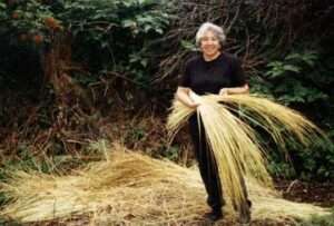 Photo:  Weaver Arlene Skinner with grass dried for weaving.
