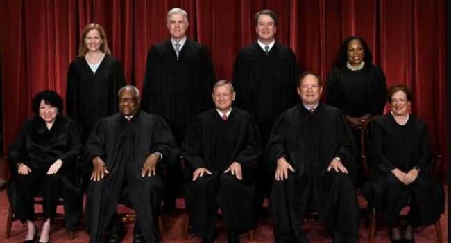 Justices of the U.S. Supreme Court pose for their official photo at the court in Washington, Oct. 7, 2022.