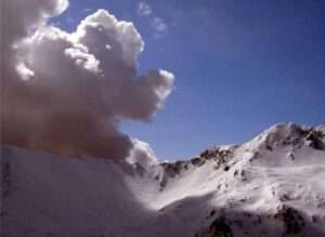 Photo: Cumulus clouds over a Kodiak peak.
