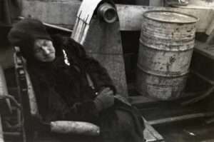 Photo:  Woman asleep in a skiff, Ouzinkie 1940s.  Smith Collections, courtesy of Tim and Norman Smith.
