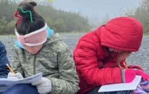 Students make science observations in their field notebooks in Portage Valley. Photo courtesy of KMTA