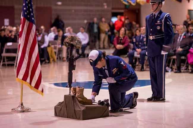 A joint forces honor guard performs the fallen warrior ceremony on Veterans Day in honor of all who served in the U.S. and Canadian military at the Alaska National Guard Armory on Joint Base Elmendorf-Richardson, Alaska, Nov. 11, 2018..."It's an honor to be in a room with so many other veterans," said Forrest Powell, the day's master of ceremonies, echoing hears in the crowd. (U.S. National Guard photo by Tech. Sgt. N. Alicia Halla /Released)