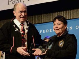 Kelly Fields accepting award from Governor Walker at AFN. Fields was joined by Cynthia Erickson and Anna Bill as winners of the 2018 Shirley Demienieff Award. Image-State of Alaska