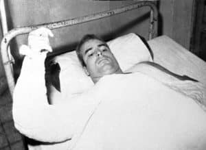 U.S. Navy Lt. Cmdr. John S. McCain lies injured in North Vietnam wearing an arm cast, in this undated photo.