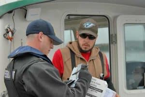 An OLE Special Agent checks charter permits.