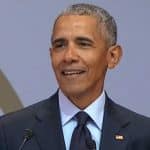 Former President Obama delivering speech in South Africa at anniversary of Nelson Mandela's birth.