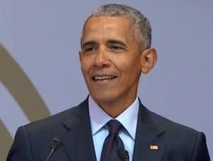 Former President Obama delivering speech in South Africa at anniversary of Nelson Mandela's birth.