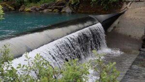 Photo by Amanda Byrd/ACEP
Water flows over Cordova Electric Cooperative’s Power Creek dam, part of a run-of-the-river hydroelectric system that uses an inflatable, adjustable barrier to divert water into the power generating plant.
