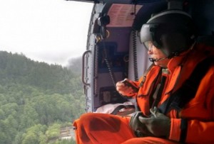 Alaska Gov. Bill Walker assesses the extent of damages caused by landslides in Sitka during an overflight aboard a Coast Guard Air Station Sitka MH-60 Jayhawk helicopter. Image-U.S. Coast Guard