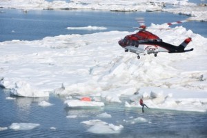An Era Helicopters crew lowers a Priority 1 Air Rescue swimmer into the Arctic Ocean during a joint search and rescue exercise near Oliktok Point, Alaska, July 13, 2015.(U.S. Coast Guard photo by Petty Officer 2nd Class Grant DeVuyst)