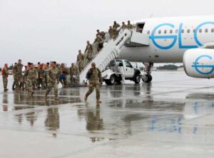 Alaska Army Guard Capt. Richard Collins, commander of Bravo Company, 1st Battalion, 297th Infantry Regiment, leads his troops on to the flight line at Joint Base Elmendorf-Richardson. Balinda O'Neal-ANG