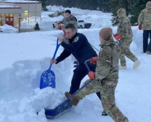 Prior to joining the Army National Guard, Spc. Brad Adams, then a member of the Yakutat Police Department, works alongside AKARNG Soldiers during snow-removal operations in Yakutat, Alaska, Jan. 14, 2022. (Alaska National Guard photo by Dana Rosso)