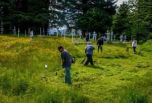 Photo: Ouzinkie residents clean the community cemetary, 2020. AM905