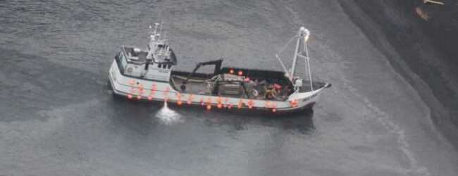 An aircrew from Coast Guard Air Station Kodiak conducts an overflight of a fishing vessel that ran aground in Izhut Bay, Kodiak, Alaska, Sept. 1, 2025. The Coast Guard is responding to the diesel released from the vessel. (U.S. Coast Guard courtesy photo)
