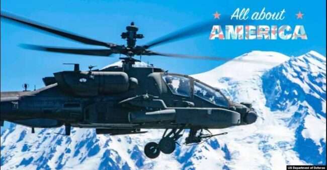 An AH-64E Apache helicopter in flight near Mount Rainier, Washington, July 11, 2022.
