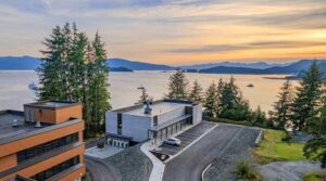 Photo: Áak’w Tá Hít (center) and the Anderson Building (left) overlooking Auke Bay in Juneau, Alaska.