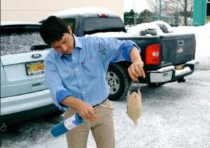 Photo: Sven Haakanson finishes cleaning a duck with a propane torch, AM723.
