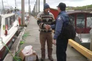 A NOAA Enforcement officer meets with a fisherman. Credit: NOAA Fisheries
