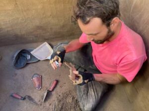 Photo courtesy of Zach Smith.
François Lanoe examines an 8,100 year-old canid mandible excavated at the Hollembaek Hill archaeological site in interior Alaska.