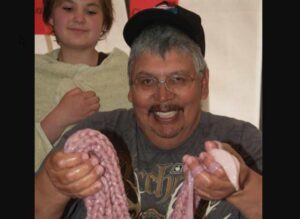 Photo:  Ronnie Lind holds some braided seal gut. Photograph by Sven Haakanson.
