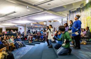 UAF photo by Leif Van Cise. Members of the Iñu-Yupiaq Dance Group share a cultural dance with attendees in the multilevel lounge area of the UAF Wood Center during the 2023 Indigenous Peoples Day Celebration on Oct. 9, 2023.