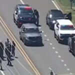 Police cars arrive at the scene of a shooting by a US Immigration and Customs Enforcement (ICE) agent in Stafford Township, New Jersey on June 15, 2026. (Screenshot from ABC 7 New York)