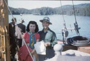 Photo: Charlie Petrone, a cannery foreman, and his wife on the dock in Ouzinkie. Oswalt Collection, AM487:6.
