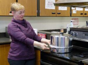 Photo courtesy of Sarah Lewis
UAF Cooperative Extension Service agent Sarah Lewis demonstrates a step in the canning process, one of many topics to be covered during Kodiak Extension Week.