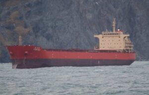 The Coast Guard continues the response, Oct. 14, 2024, to Pan Viva, a 738-foot cargo vessel, beset by weather 2.3 miles northeast of Unalaska, Alaska. Coast Guard Cutter Stratton (WMSL 752) and a tug from Dutch Harbor are on scene to assist. Pan Viva will evaluate weighing anchor as weather subsides. Coast Guard photo courtesy of CGC Stratton.
