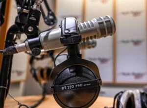 A microphone and headsets are seen in a radio broadcast studio.